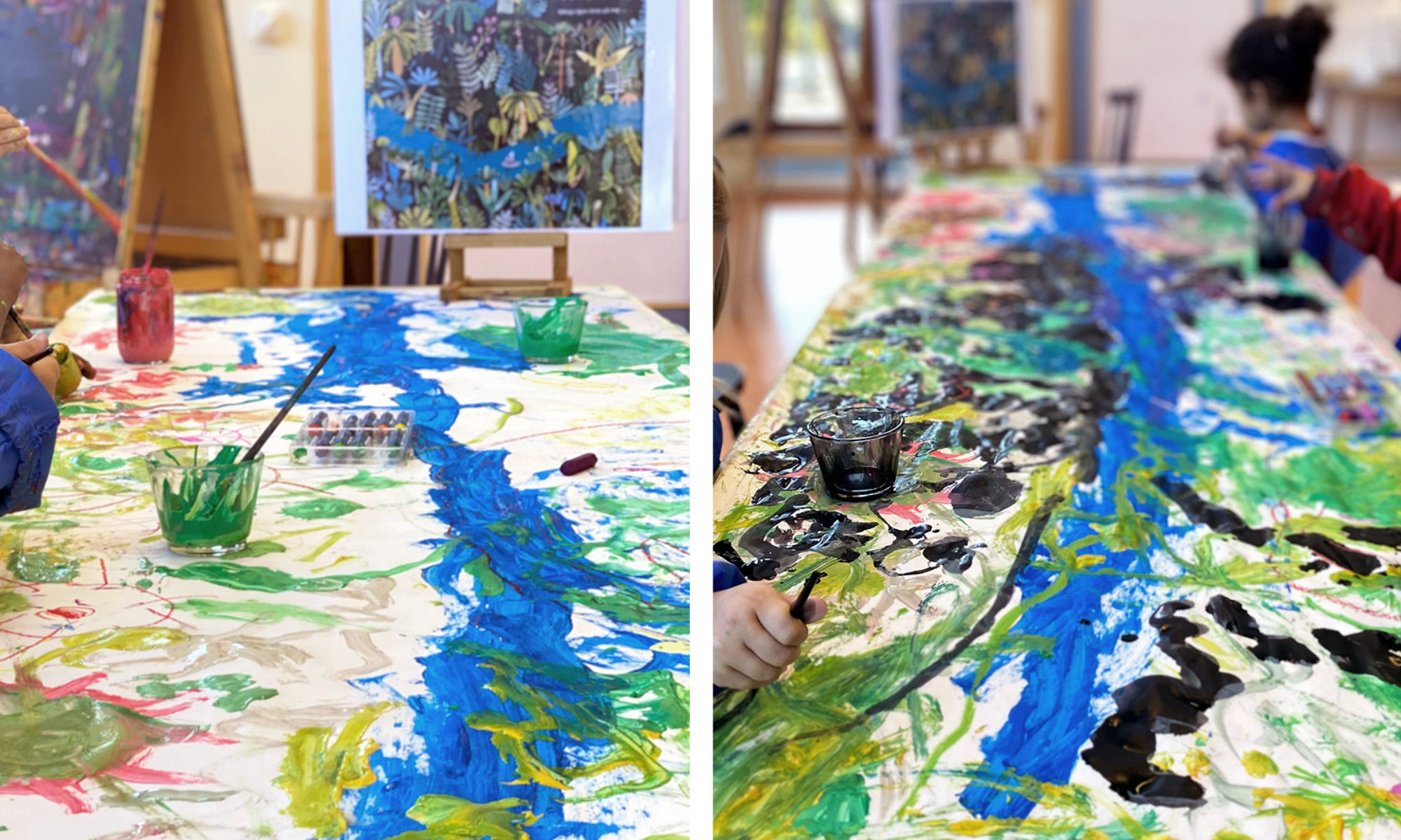 En stor yta där barn har målat med färger i blått, grönt, gult och svart. Några barnhänder och penslar skymtar från sidan.